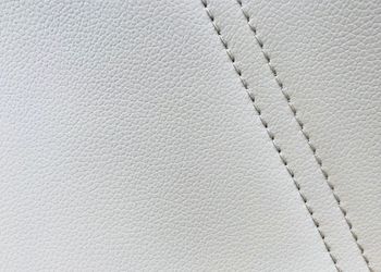 Macro shot of white stitched leather