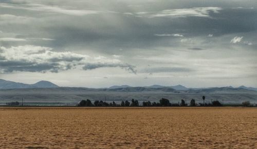 Scenic view of mountains against cloudy sky