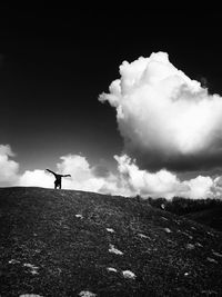 Man standing on field against sky