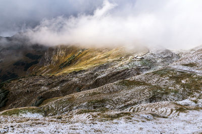 Scenic view of mountains against cloudy sky