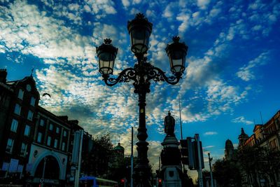 Low angle view of street light and buildings against sky