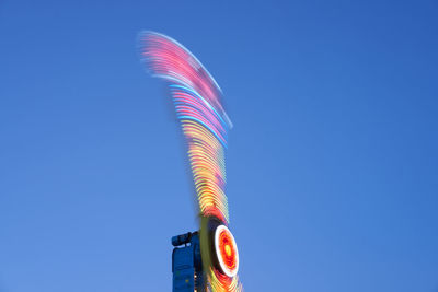 Low angle view of illuminated light against blue sky