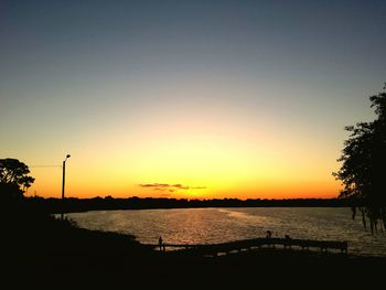 Scenic view of sea against clear sky during sunset