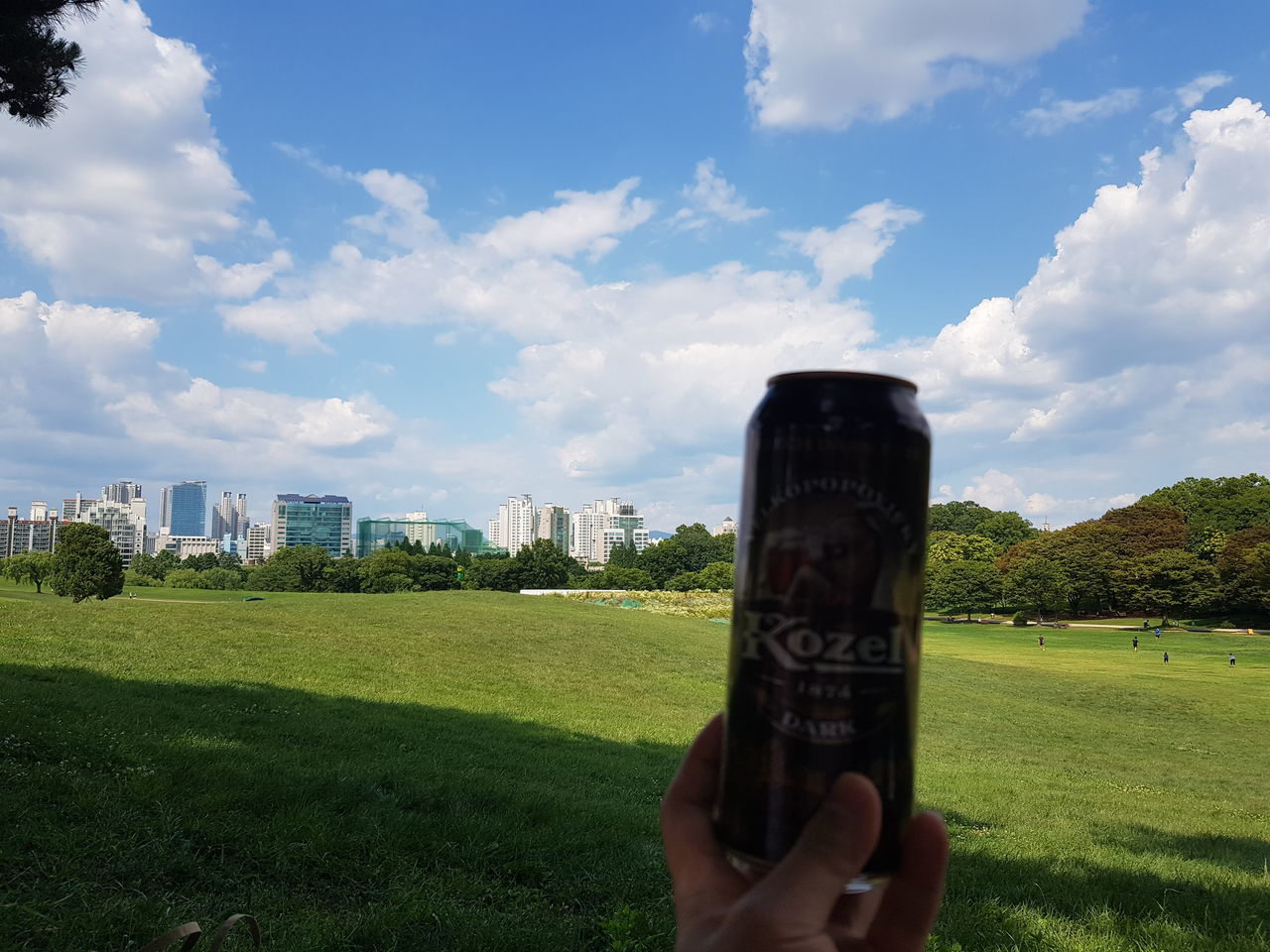MAN HOLDING UMBRELLA AGAINST SKY