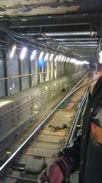 Man moving in illuminated train at night