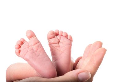 Close-up of human hand over white background