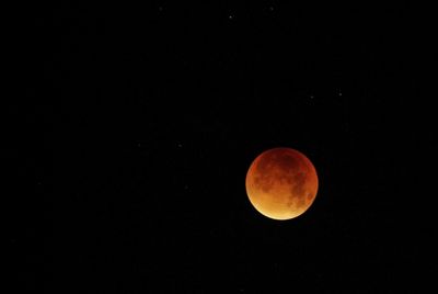 Scenic view of moon against clear sky at night