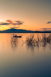 Scenic view of lake against sky during sunset