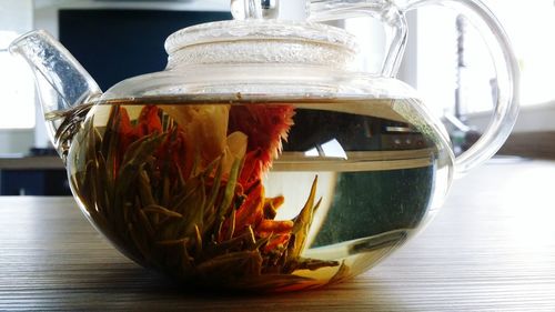 Close-up of drink in teapot on table