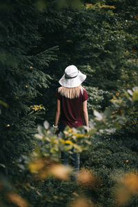 Rear view of woman walking on field