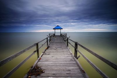 Pier over sea against sky