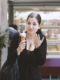 Portrait of smiling young woman with ice cream