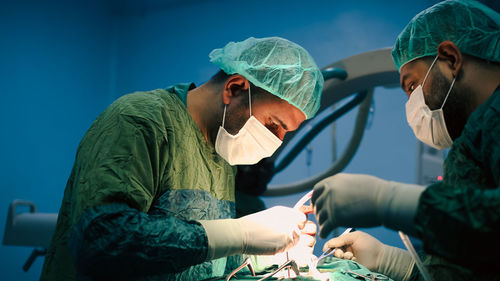 Team of surgeons doing an operation. sterile operating room.