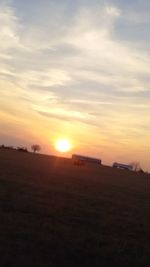 Scenic view of field against sky during sunset