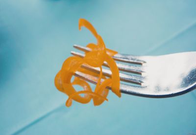 High angle view of fork on table with curly carrot