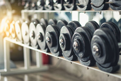 Close-up of dumbbells arranged on rack