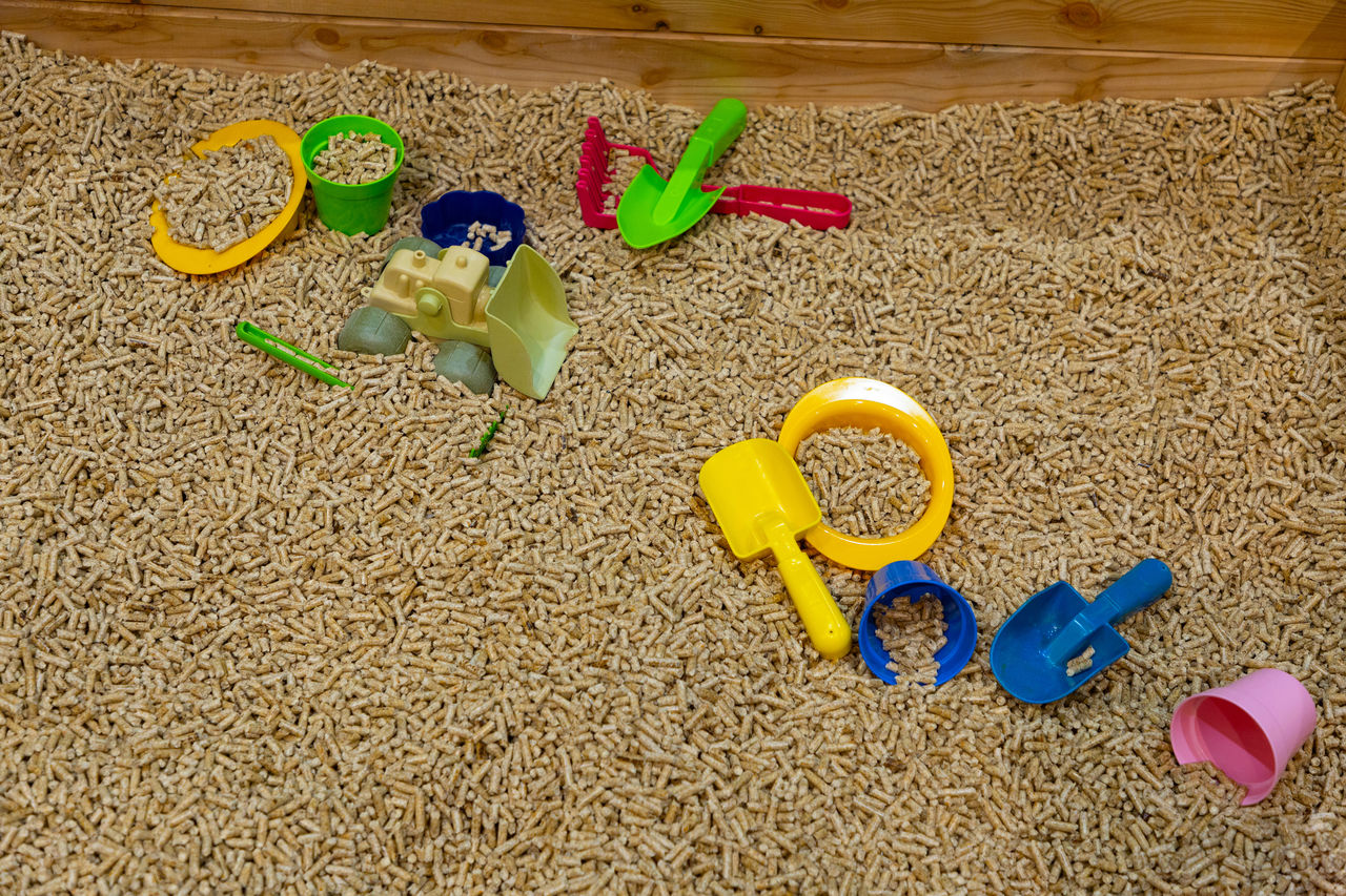 sand, beach, land, high angle view, childhood, toy, yellow, nature, multi colored, still life, holiday, day, plastic