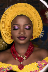 Close-up of young woman wearing jewelry and make-up