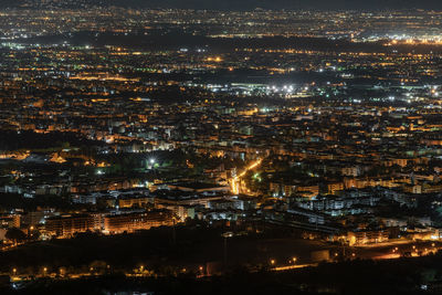 High angle view of illuminated buildings in city at night