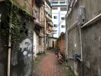 Narrow alley amidst buildings in city