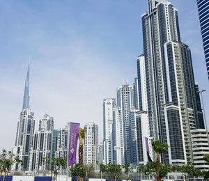 Low angle view of burj khalifa with cityscape against sky