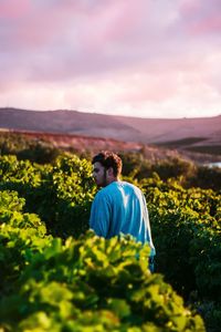 Young man in vineyard