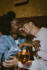 Affectionate couple enjoying with each other during date at bar