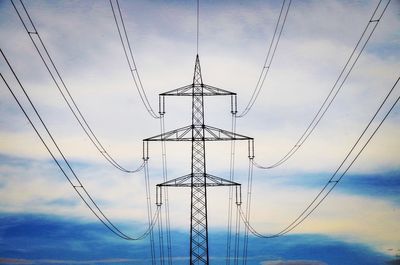 Low angle view of electricity pylon against sky