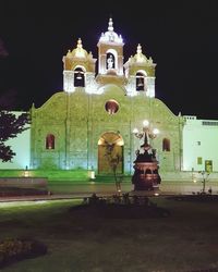 Facade of historic building against sky at night