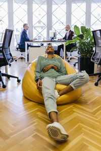 People sitting on wooden floor