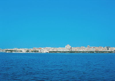 View of built structures against clear blue sky