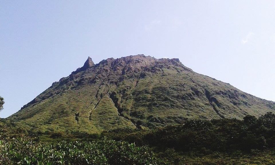 mountain, clear sky, tranquility, low angle view, tranquil scene, rock formation, scenics, sky, nature, beauty in nature, rocky mountains, cliff, rock - object, landscape, mountain range, non-urban scene, copy space, physical geography, hill, geology