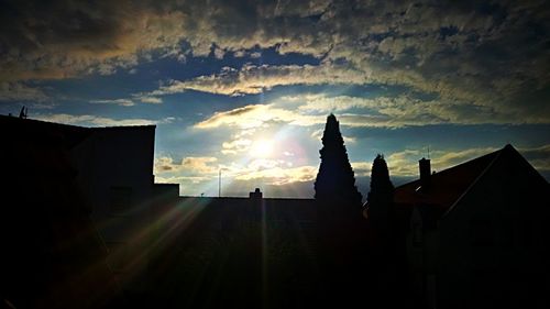 Low angle view of silhouette built structure against sky