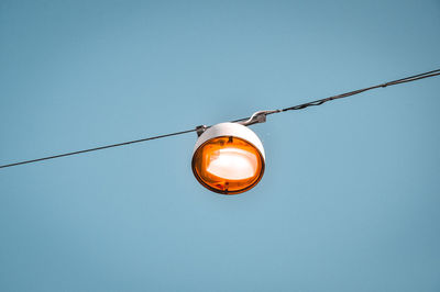 Low angle view of light bulb against clear sky