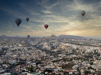 Hot air balloons flying over landscape