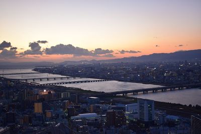 High angle view of city and buildings at sunset