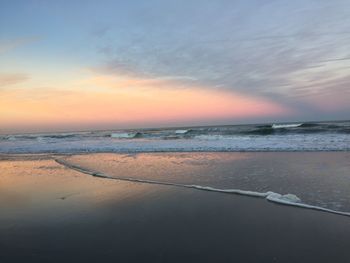 Scenic view of beach against sky during sunset