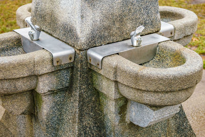Close-up of stone sculptures water fountain  - monotone. 