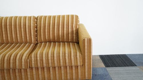 Close-up of sofa against wall