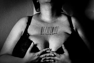 Midsection of shirtless woman