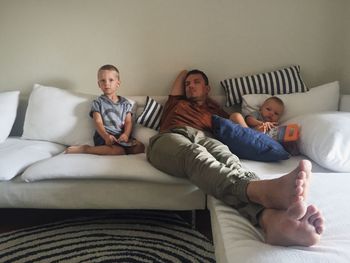 Portrait of young woman sitting on sofa