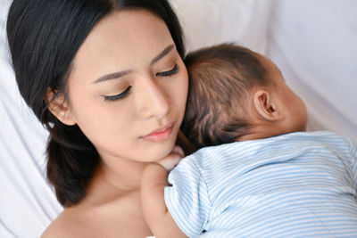 Close-up of mother with baby boy at home