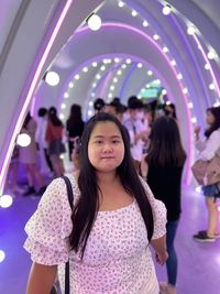 Portrait of smiling young woman standing in tunnel