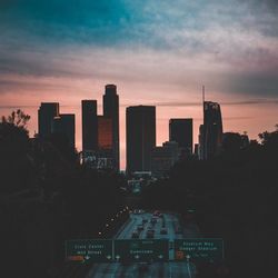 View of cityscape against cloudy sky