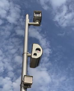 Low angle view of telephone pole against sky