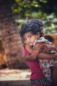 Portrait of cute girl with arms raised