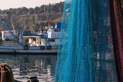 Fishing net hanging from boat in water