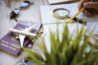 High angle view of hand holding book on table