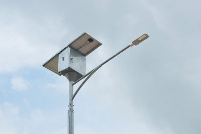 Led street light with solar cell panel on blue sky background