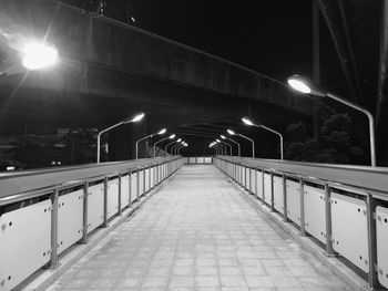 Illuminated street lights on bridge at night